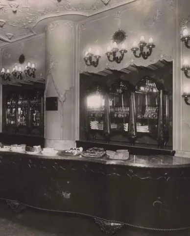 Historic interior of Myšák pastry shop with counter and display cases.